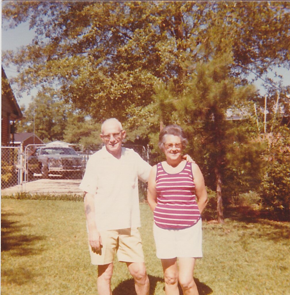 Grandma and Grandpa in their yard in Montgomery