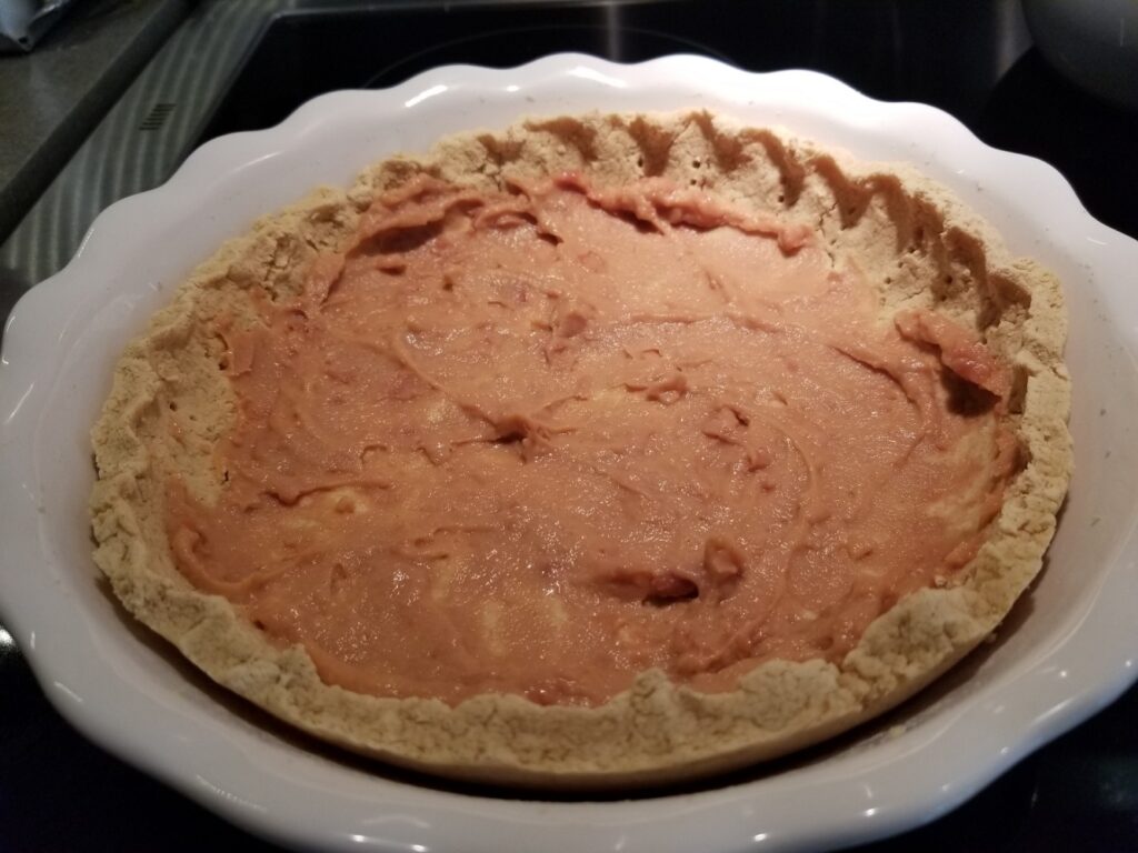 refried beans in a masa harina crust