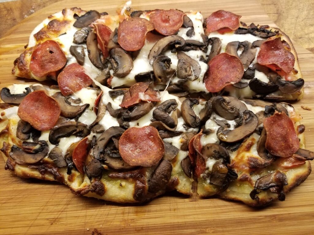 Sourdough Pizza Crust topped with mushrooms and pepperoni