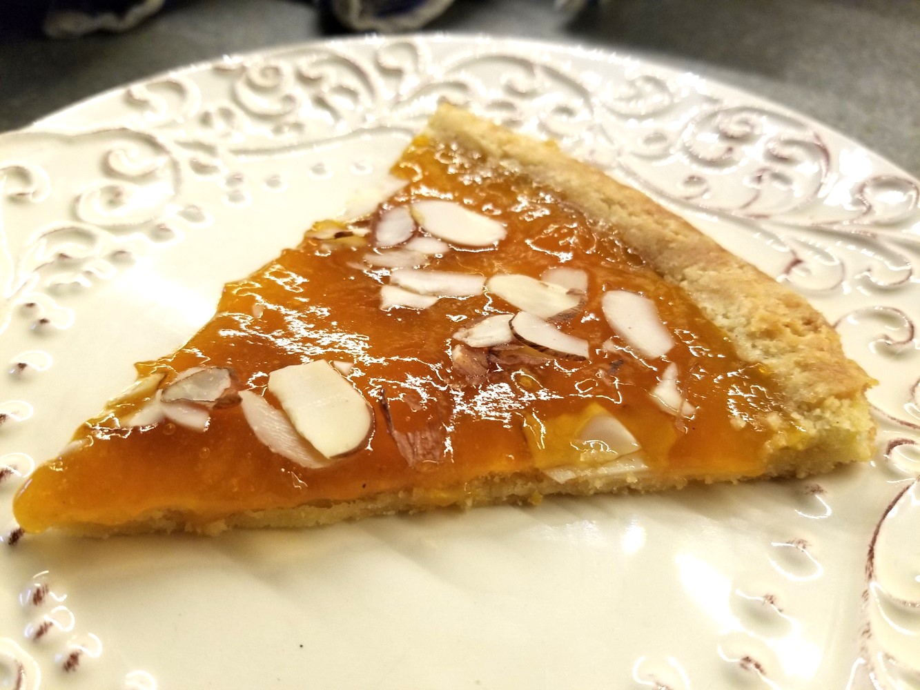 flaky apricot jam tart with almond slivers