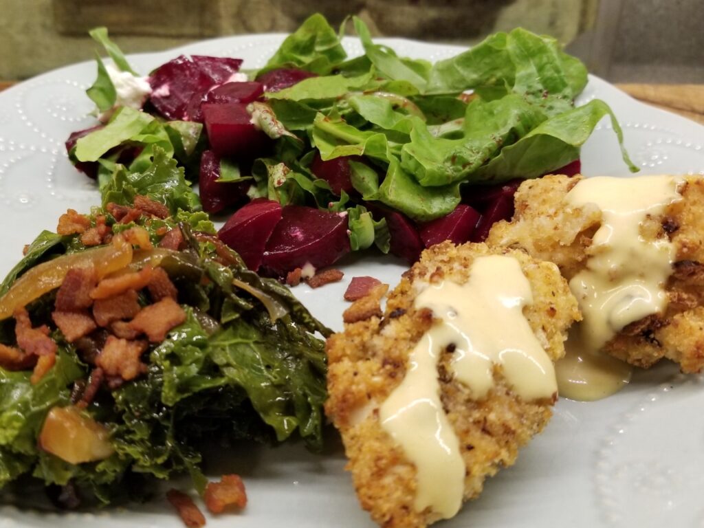 chicken tenders and honey mustard sauce with sauteed kale and roasted beet salad