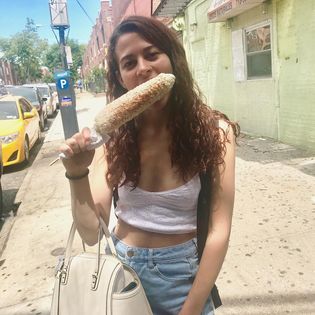 Angie eating Mexican Street Corn