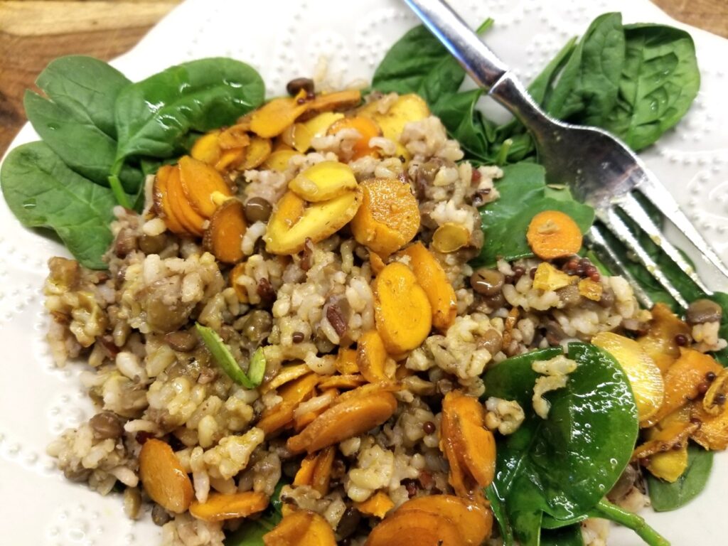 Ginger Turmeric Condiment over brown rice pilaf and a bed of baby spinach